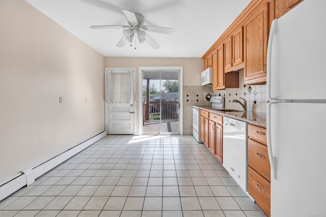 kitchen with white appliances, sink, a baseboard radiator, backsplash, and light tile patterned floors