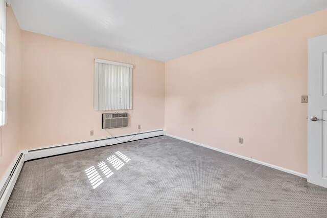 unfurnished room with a baseboard heating unit, a wall mounted air conditioner, and carpet