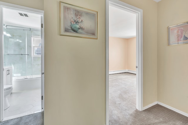 corridor featuring carpet floors and baseboard heating