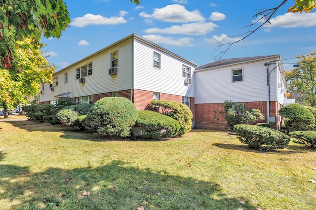 view of side of property with cooling unit and a yard