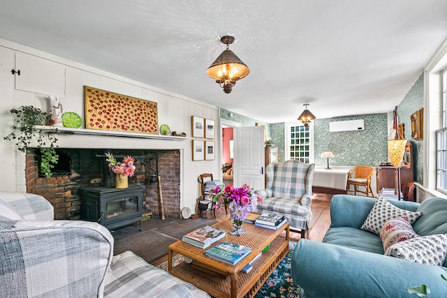 living room featuring a wood stove and a wall unit AC