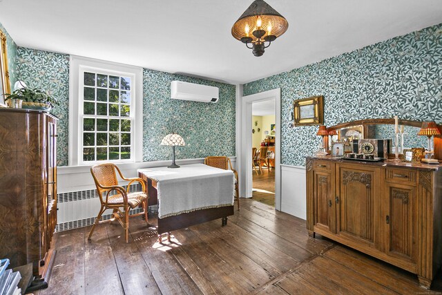 dining area with an inviting chandelier, radiator heating unit, dark hardwood / wood-style flooring, and a wall mounted AC