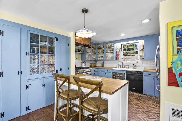 kitchen featuring blue cabinets, dishwasher, sink, and butcher block counters