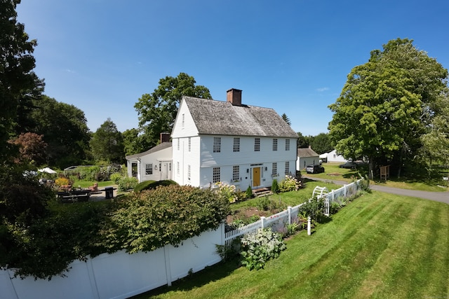 back of house with a lawn