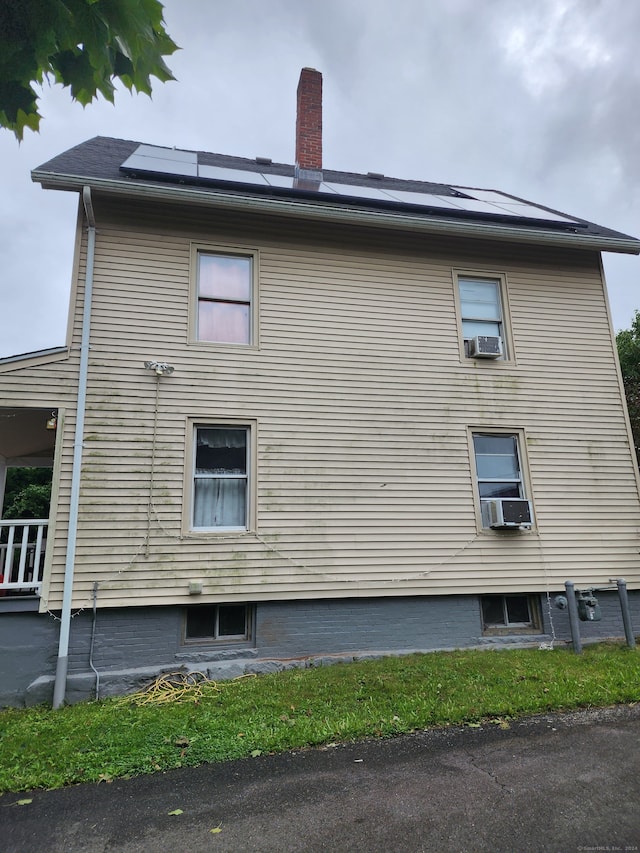 view of property exterior featuring cooling unit and solar panels