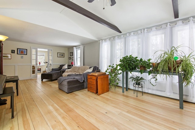 living room with hardwood / wood-style flooring and lofted ceiling with beams