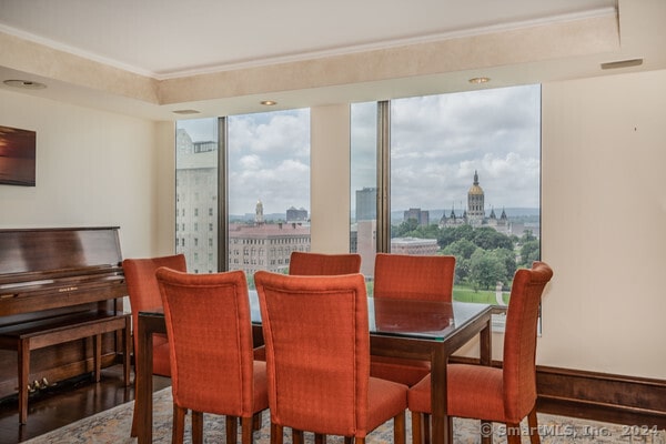 dining space with crown molding and hardwood / wood-style floors