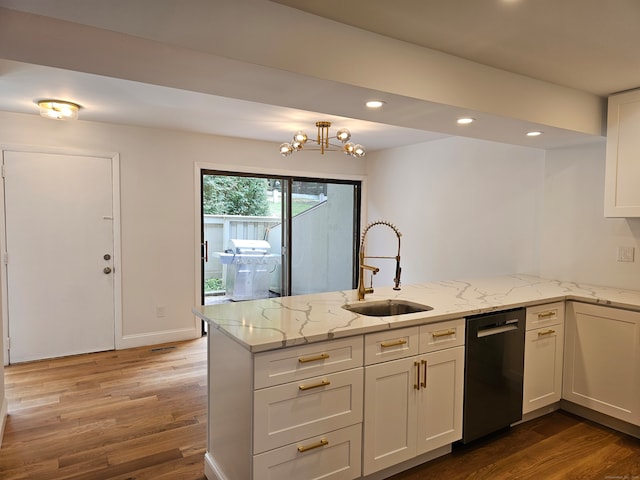 kitchen with light stone countertops, stainless steel dishwasher, sink, kitchen peninsula, and light hardwood / wood-style flooring