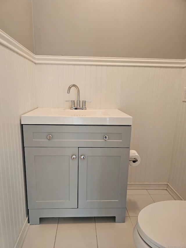 bathroom with vanity, tile patterned flooring, and toilet