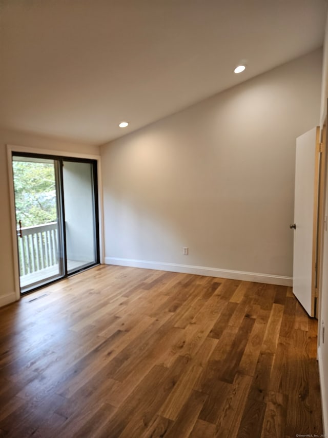 spare room with hardwood / wood-style flooring