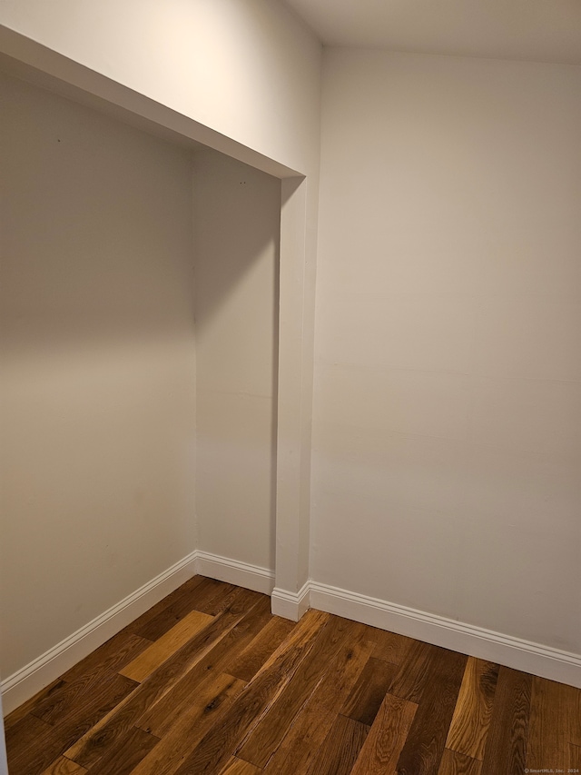 empty room featuring dark wood-type flooring