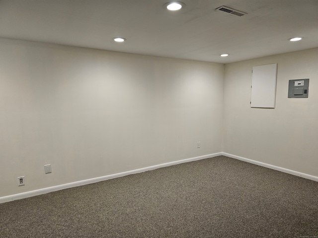 empty room featuring electric panel and carpet