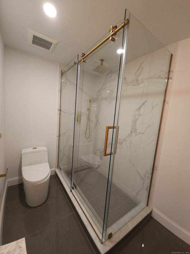 bathroom with tile patterned floors, walk in shower, and toilet