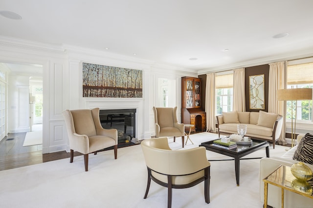 865 Hollow Tree Ridge Rd, Darien, CT 06820 - living area with crown molding, a glass covered fireplace, plenty of natural light, and a decorative wall