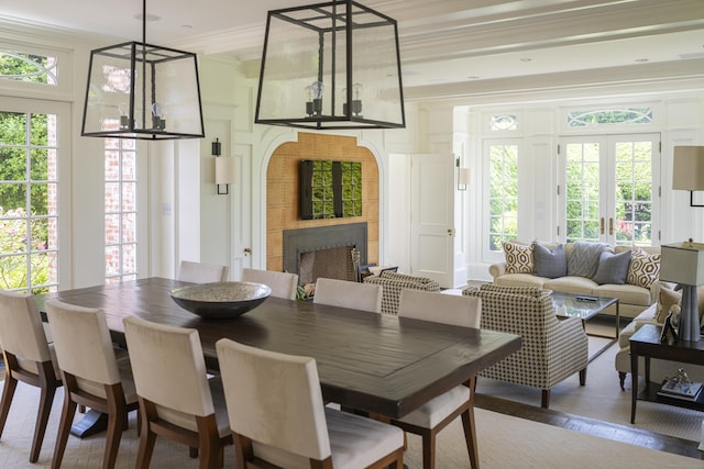 865 Hollow Tree Ridge Rd, Darien, CT 06820 - dining space featuring crown molding, a tile fireplace, and healthy amount of natural light