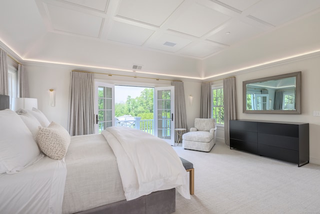 carpeted bedroom featuring multiple windows, coffered ceiling, and access to exterior