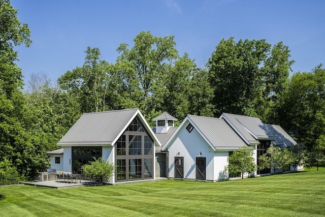 865 Hollow Tree Ridge Rd, Darien, CT 06820 - rear view of house featuring a lawn, metal roof, and a patio area
