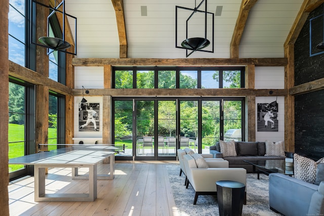 sunroom featuring wood ceiling, lofted ceiling with beams, and a healthy amount of sunlight