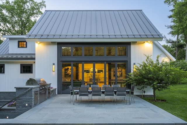865 Hollow Tree Ridge Rd, Darien, CT 06820 - back of house with a standing seam roof, area for grilling, a patio area, and metal roof