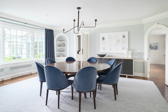 dining room with a chandelier, radiator, dark hardwood / wood-style flooring, and crown molding