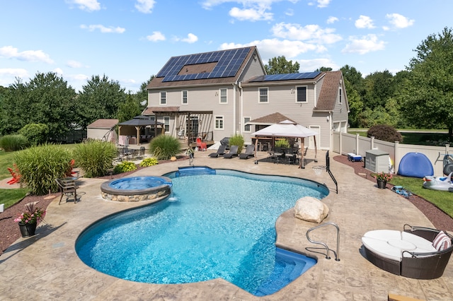 view of pool with a gazebo, a patio area, and an in ground hot tub