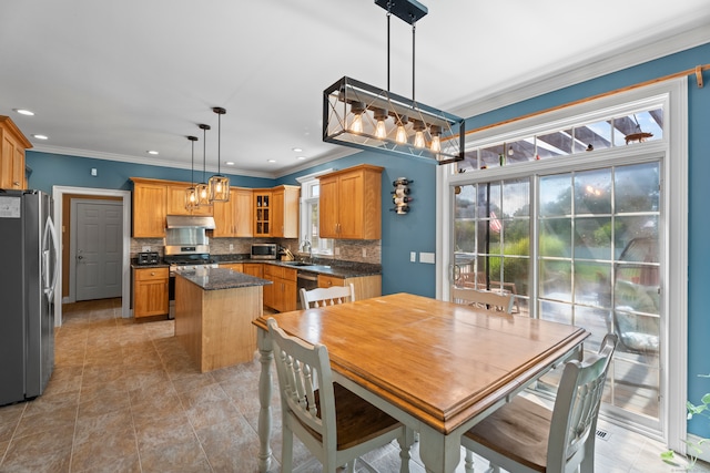 dining area featuring ornamental molding and sink