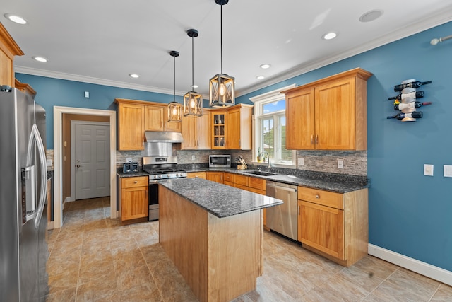 kitchen with dark stone counters, stainless steel appliances, a kitchen island, sink, and hanging light fixtures