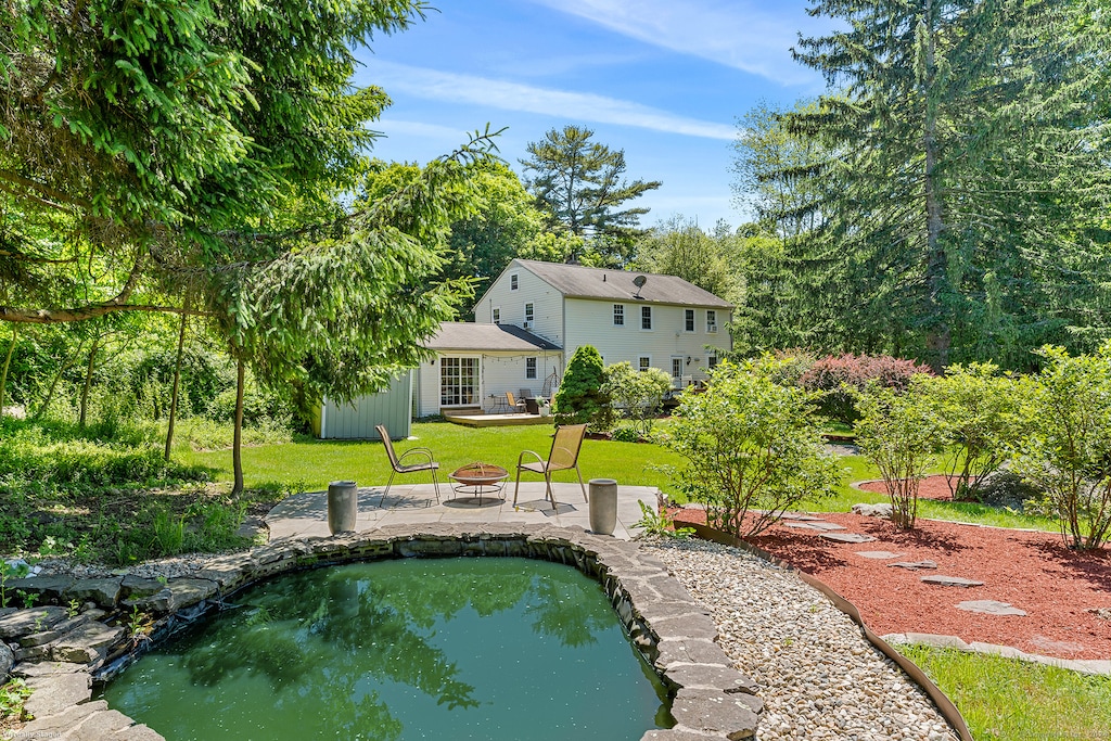 exterior space featuring a fire pit, a patio, and a yard