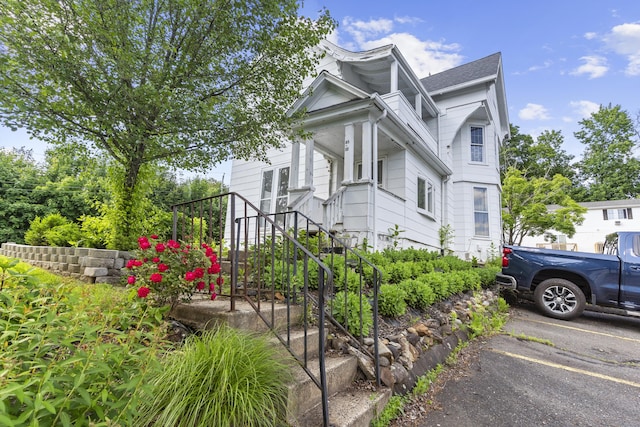 85 Aetna St Apt 12, Naugatuck, CT 06770 - view of home's exterior featuring stairs and uncovered parking