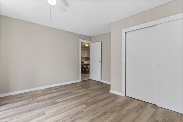 85 Aetna St Apt 12, Naugatuck, CT 06770 - unfurnished bedroom with wood finished floors, a closet, a ceiling fan, and baseboards