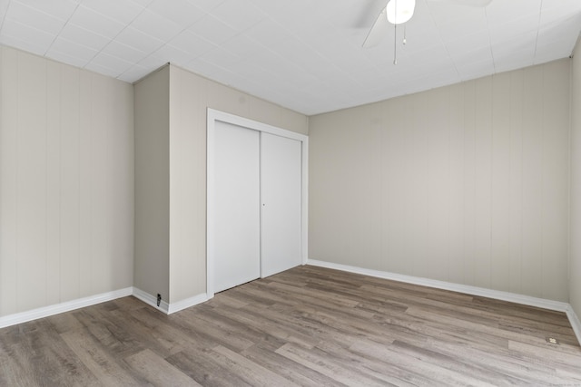 85 Aetna St Apt 12, Naugatuck, CT 06770 - unfurnished bedroom with wood finished floors, a closet, a ceiling fan, and baseboards