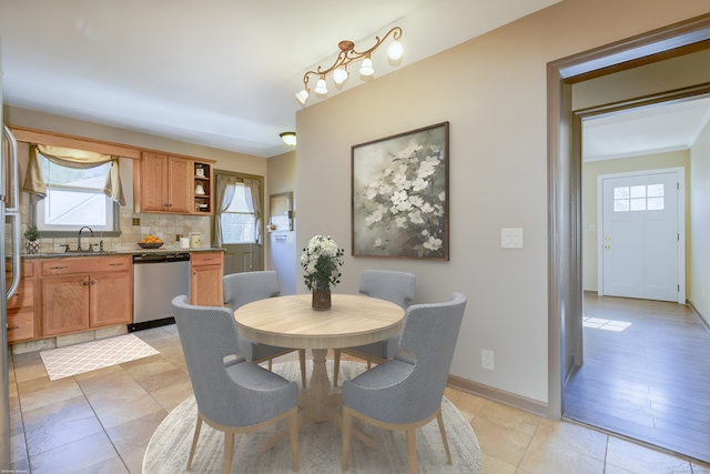 dining space with light hardwood / wood-style floors and sink