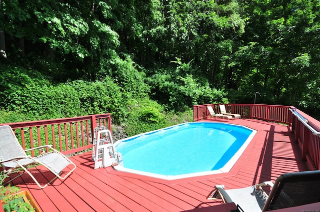 view of swimming pool featuring a wooden deck