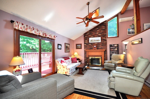 living room featuring ceiling fan, light wood-type flooring, vaulted ceiling, and a brick fireplace