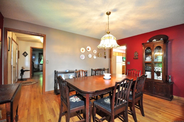 dining room featuring light hardwood / wood-style floors and a chandelier