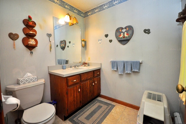 bathroom featuring tile patterned floors, heating unit, vanity, and toilet