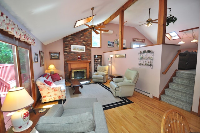 living room featuring a brick fireplace, ceiling fan, hardwood / wood-style floors, and a baseboard heating unit