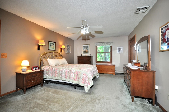 bedroom featuring carpet flooring, ceiling fan, baseboard heating, and a textured ceiling