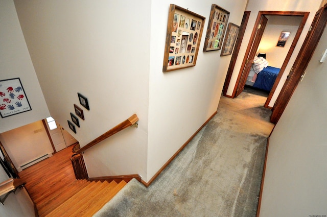 hallway featuring a baseboard radiator and light hardwood / wood-style floors