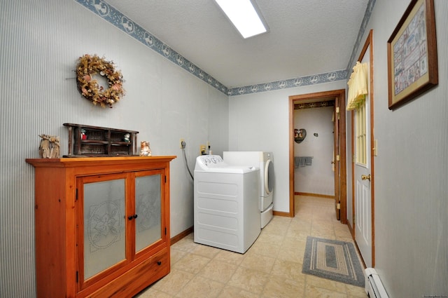 laundry room with a textured ceiling, a baseboard radiator, and washing machine and clothes dryer