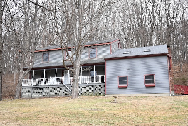 view of front of house with a front yard and a porch