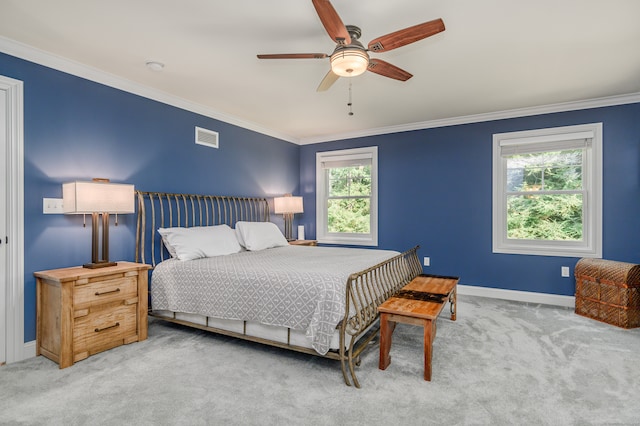 bedroom with light carpet, multiple windows, and ceiling fan