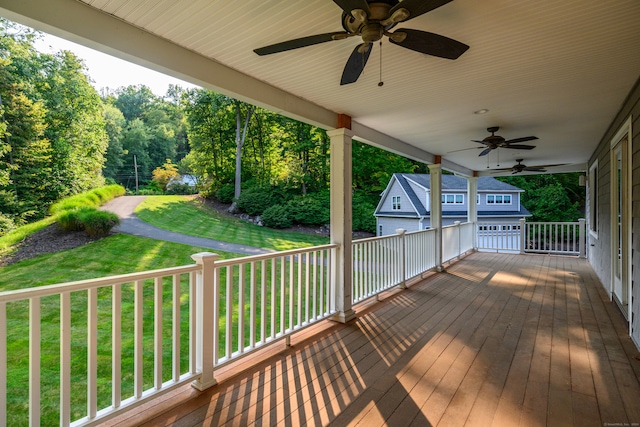 deck featuring a yard and ceiling fan