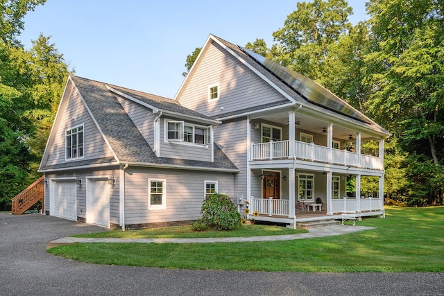 exterior space with a front yard, a porch, a balcony, and a garage