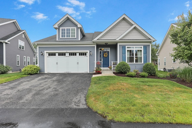 view of front of home with a garage and a front lawn