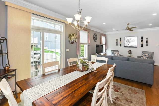 dining room with ornamental molding, hardwood / wood-style flooring, and ceiling fan with notable chandelier