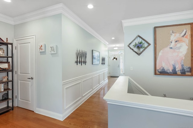 corridor with wood-type flooring and crown molding