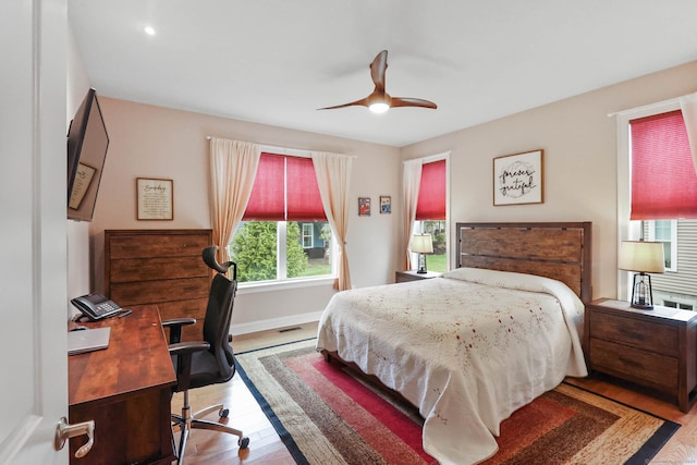 bedroom with hardwood / wood-style flooring and ceiling fan