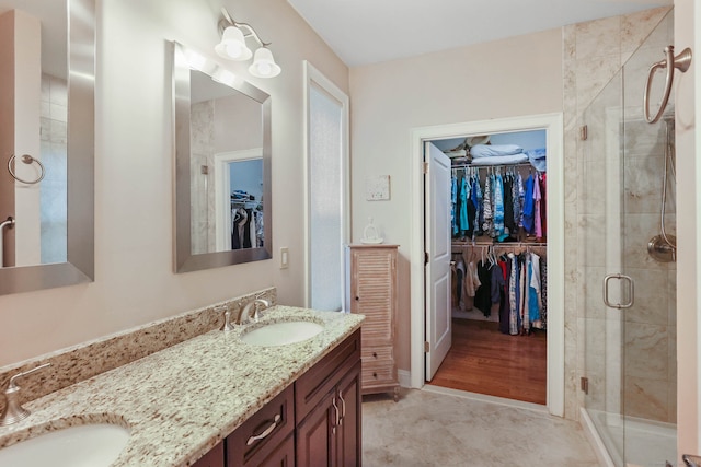 bathroom featuring vanity, an enclosed shower, and wood-type flooring