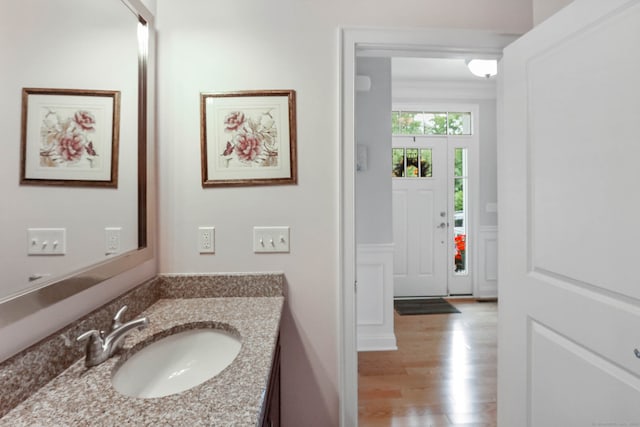 bathroom with hardwood / wood-style floors and vanity